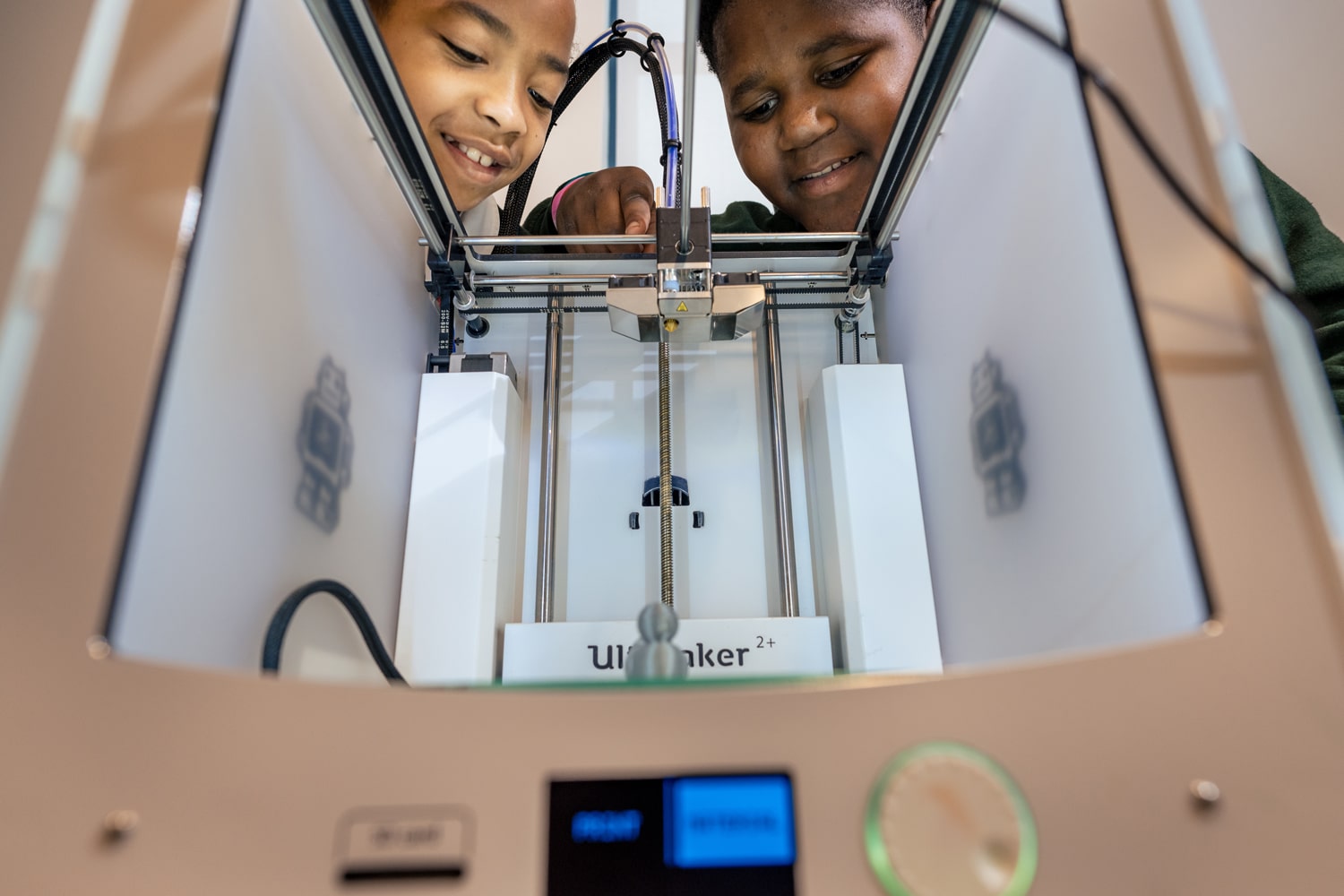 students watching a 3d printer